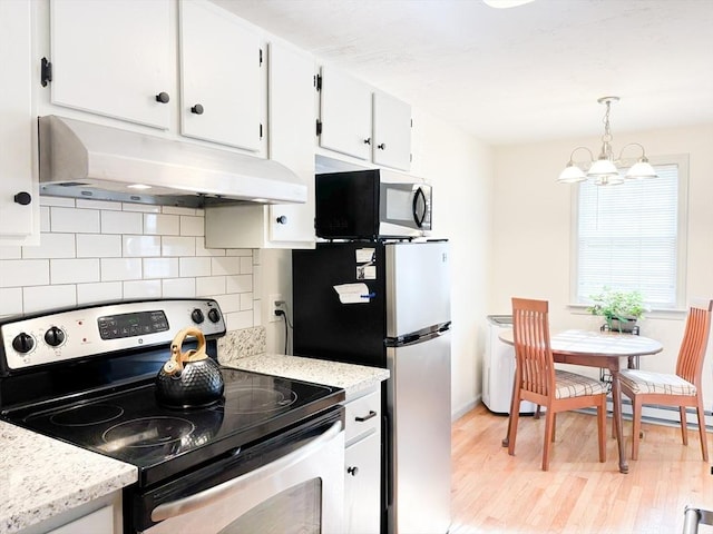 110 W Main St Unit 30, Barnstable, MA 02601 - kitchen with appliances with stainless steel finishes, under cabinet range hood, light wood-style floors, backsplash, and white cabinetry