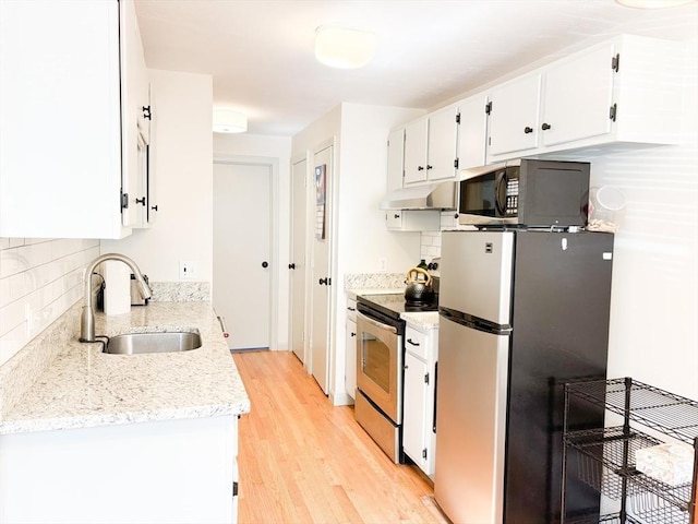 110 W Main St Unit 30, Barnstable, MA 02601 - kitchen with appliances with stainless steel finishes, a sink, under cabinet range hood, white cabinetry, and backsplash