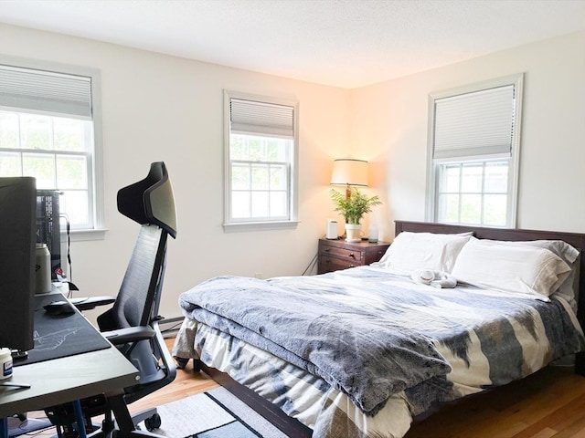 110 W Main St Unit 30, Barnstable, MA 02601 - bedroom featuring multiple windows, wood finished floors, and a desk