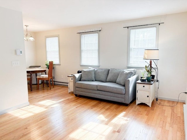 110 W Main St Unit 30, Barnstable, MA 02601 - living area with light wood-type flooring, a chandelier, and baseboards