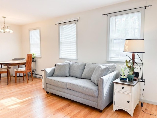 110 W Main St Unit 30, Barnstable, MA 02601 - living room featuring light wood-style flooring, plenty of natural light, a chandelier, and baseboards