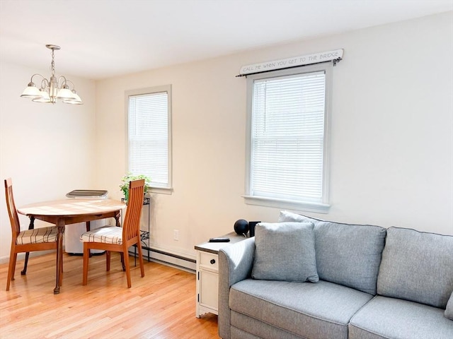 110 W Main St Unit 30, Barnstable, MA 02601 - dining space with a chandelier, healthy amount of natural light, light wood-style flooring, and a baseboard radiator