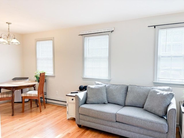 110 W Main St Unit 30, Barnstable, MA 02601 - living room featuring a chandelier, light wood-style floors, plenty of natural light, and baseboard heating