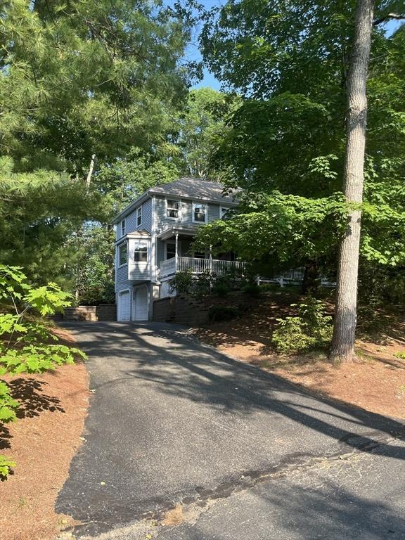 15 Shufelt Rd, Walpole, MA 02071 - view of front of house with a garage and asphalt driveway