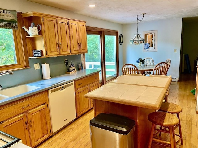 15 Shufelt Rd, Walpole, MA 02071 - kitchen with white dishwasher, light wood-style flooring, a breakfast bar area, open shelves, and recessed lighting
