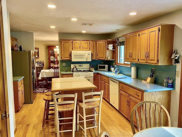 15 Shufelt Rd, Walpole, MA 02071 - kitchen with white appliances, tile counters, a sink, a kitchen island, and light wood finished floors