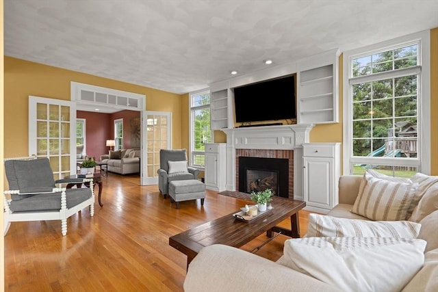 160 Wharton Row, Groton, MA 01450 - living area with a brick fireplace, wood finished floors, and built in features