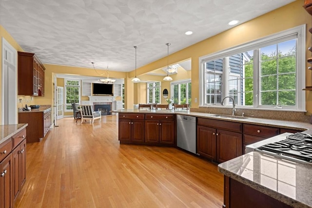 160 Wharton Row, Groton, MA 01450 - kitchen with dishwasher, a glass covered fireplace, open floor plan, plenty of natural light, and recessed lighting