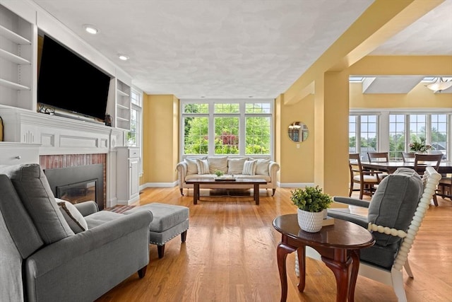 160 Wharton Row, Groton, MA 01450 - living room with wood finished floors, a fireplace, built in shelves, and recessed lighting