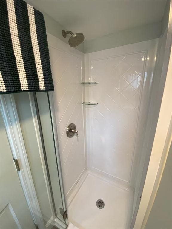 bathroom featuring a shower with shower door