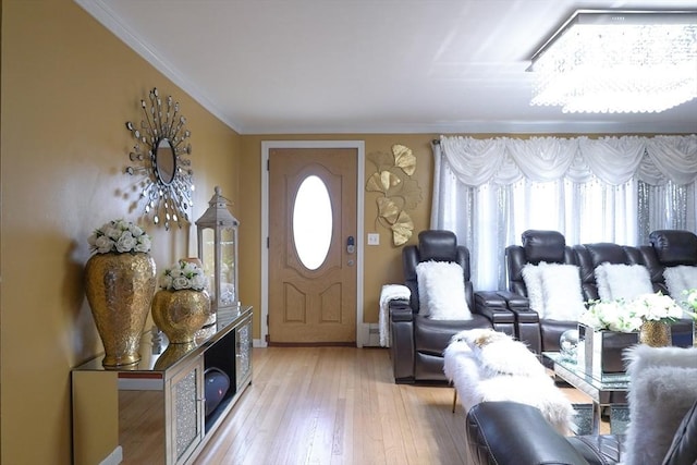 entrance foyer featuring a healthy amount of sunlight, crown molding, and light wood-type flooring