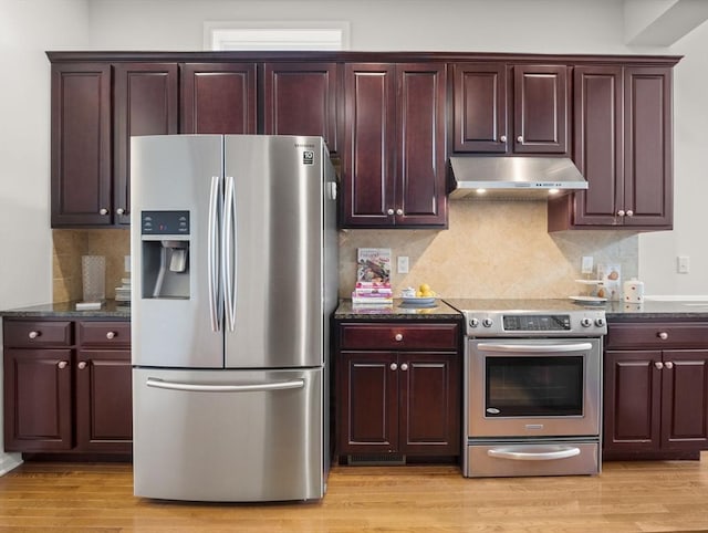 72 Sherwood Dr Unit 72, Methuen, MA 01844 - kitchen with stainless steel appliances, range hood, light wood-style floors, decorative backsplash, and dark stone countertops