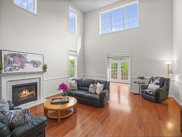 72 Sherwood Dr Unit 72, Methuen, MA 01844 - living room with a high ceiling, hardwood / wood-style floors, healthy amount of natural light, and a fireplace with flush hearth