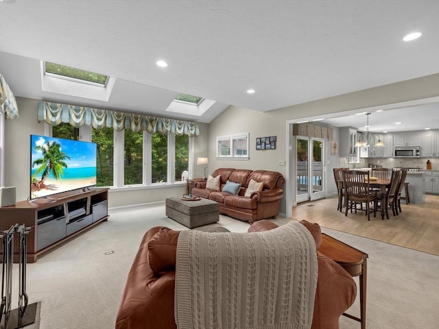 1 Benjamin Dr, Westborough, MA 01581 - living room featuring a skylight, recessed lighting, light colored carpet, a chandelier, and baseboards