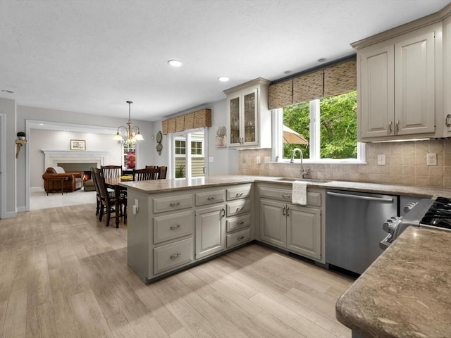 1 Benjamin Dr, Westborough, MA 01581 - kitchen with stainless steel dishwasher, a sink, a peninsula, gray cabinetry, and light wood finished floors