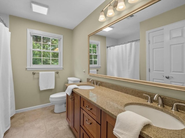1 Benjamin Dr, Westborough, MA 01581 - full bath featuring plenty of natural light, double vanity, toilet, and baseboards