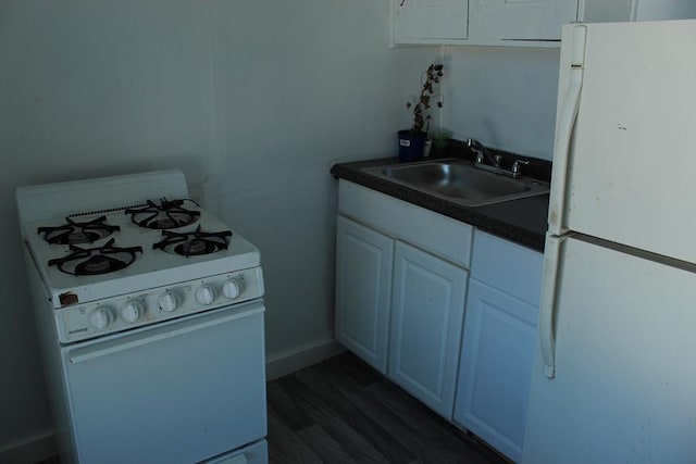 223 Morgan St, Fall River, MA 02721 - kitchen featuring white appliances, a sink, dark countertops, and dark wood-style flooring