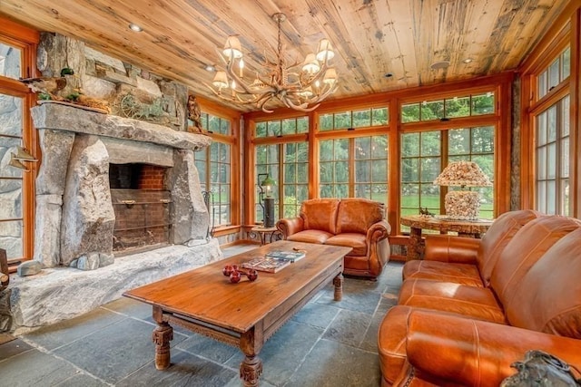 interior space featuring a stone fireplace, wooden ceiling, and an inviting chandelier