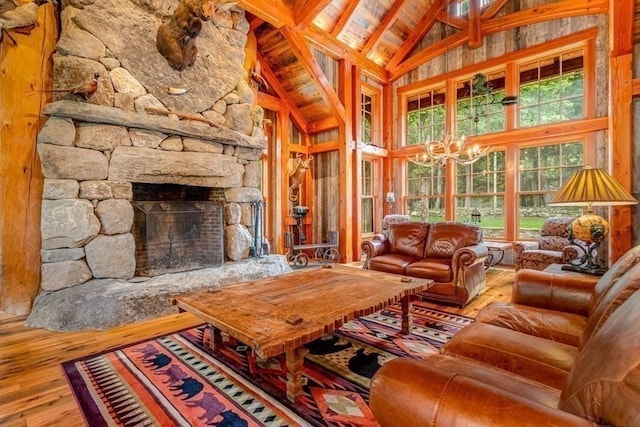 sunroom / solarium featuring a fireplace, vaulted ceiling with beams, a notable chandelier, and wood ceiling