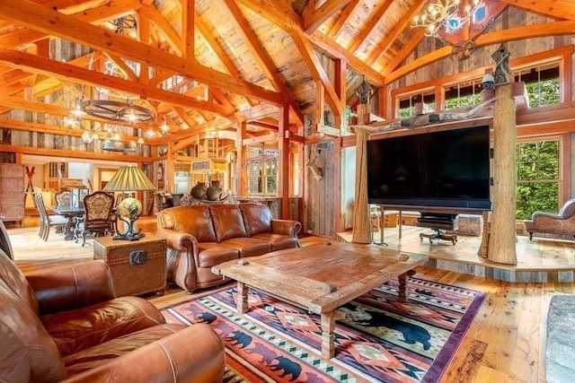 living room with an inviting chandelier, beamed ceiling, high vaulted ceiling, and hardwood / wood-style flooring