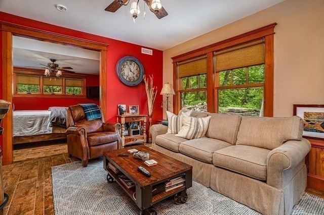 living room featuring hardwood / wood-style floors and ceiling fan