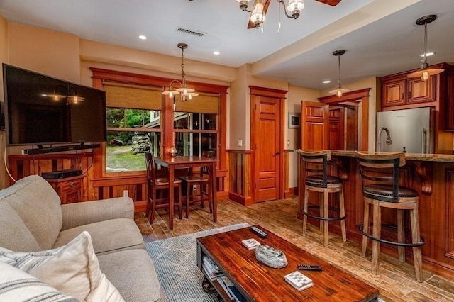 living room featuring a chandelier and hardwood / wood-style floors