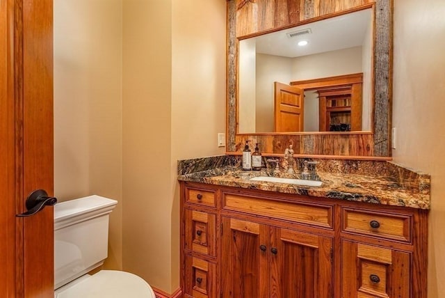 bathroom featuring vanity and toilet