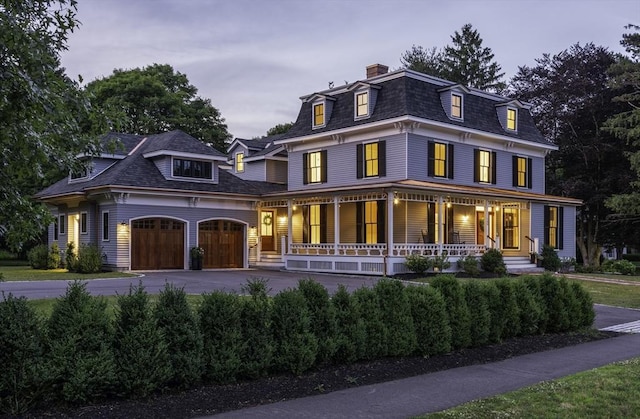 view of front of house with a porch and a garage