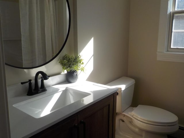 bathroom featuring vanity and toilet