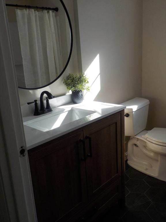 full bathroom featuring tile patterned floors, toilet, and vanity