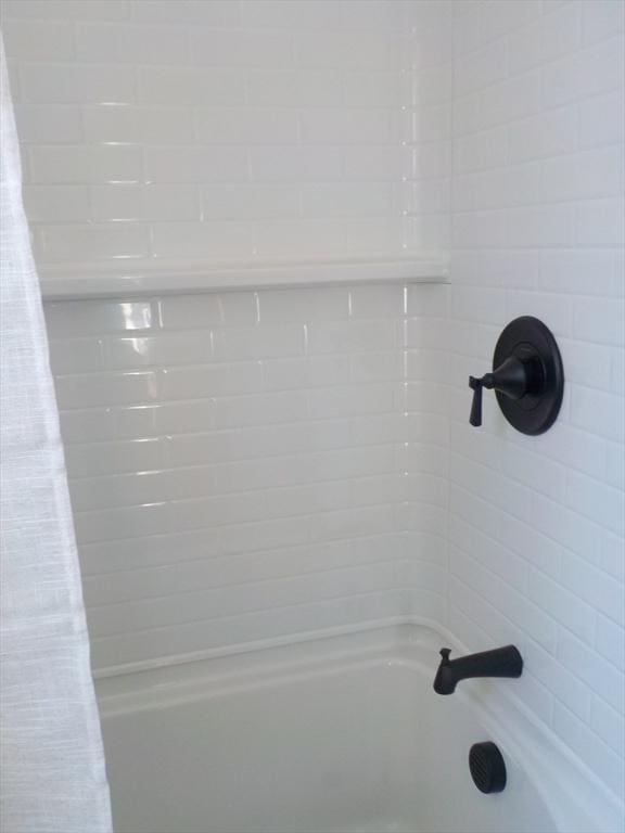 interior details with shower / bath combination with curtain