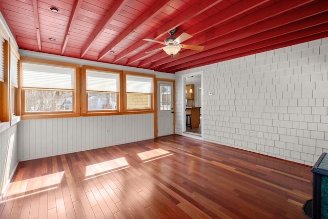 interior space with beamed ceiling and a ceiling fan