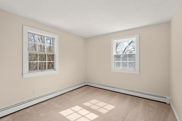 unfurnished room with a baseboard radiator and carpet floors