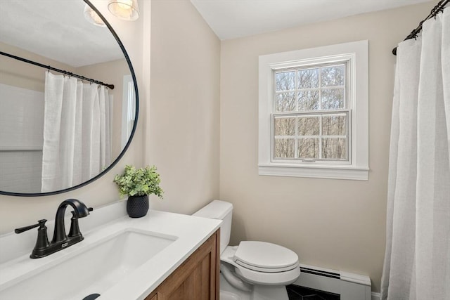 bathroom with vanity, toilet, and baseboard heating