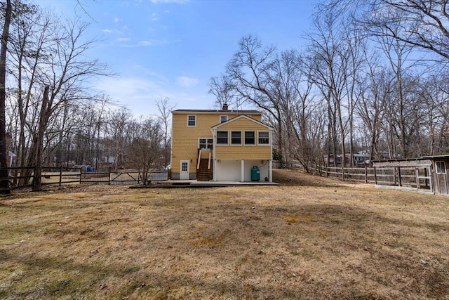 rear view of property with fence, a lawn, and a chimney