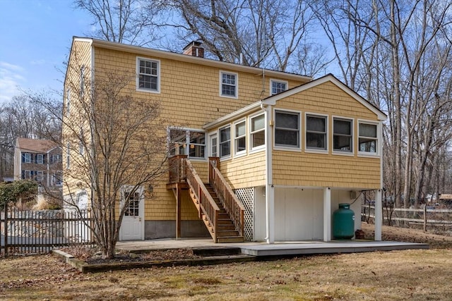 back of property featuring a patio, stairway, and fence