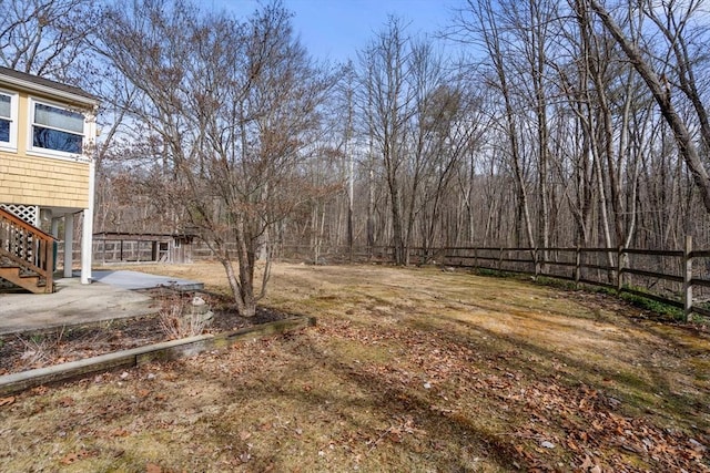 view of yard with stairway and fence