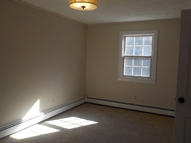 carpeted spare room with baseboard heating and ornamental molding