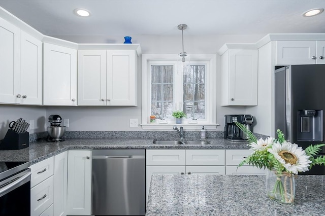 kitchen featuring stainless steel appliances, sink, and white cabinets