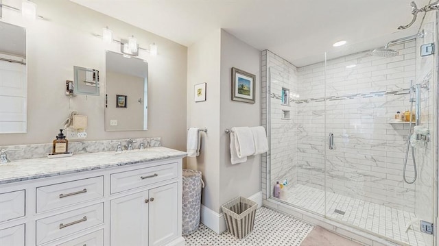 bathroom featuring vanity, tile patterned flooring, and walk in shower