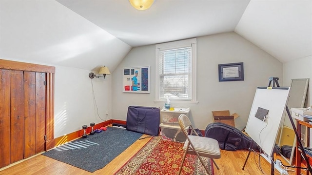 interior space with lofted ceiling and hardwood / wood-style floors