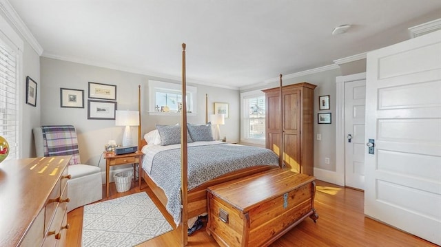 bedroom with ornamental molding and light hardwood / wood-style floors