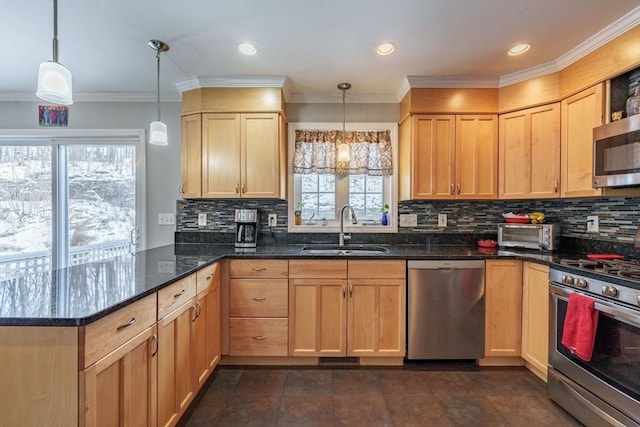 kitchen featuring dark stone counters, stainless steel appliances, light brown cabinetry, pendant lighting, and a sink