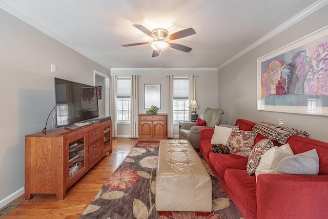 living area with light wood-type flooring, baseboards, ornamental molding, and a ceiling fan