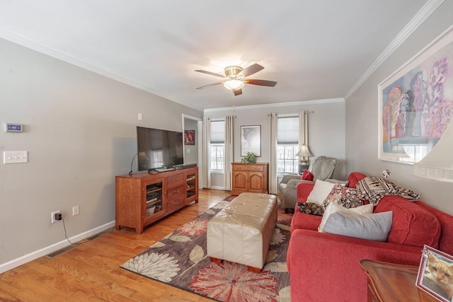 living room featuring crown molding, visible vents, light wood-style floors, ceiling fan, and baseboards