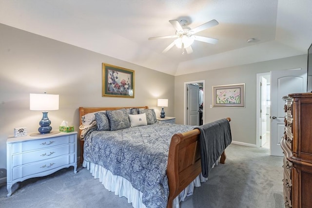 bedroom with lofted ceiling, carpet floors, a ceiling fan, baseboards, and a spacious closet