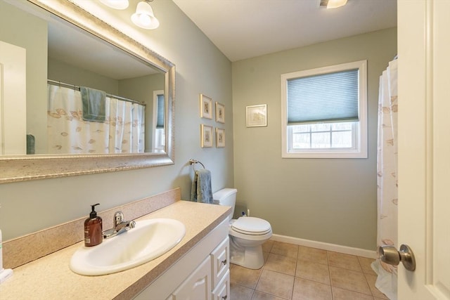 full bath with toilet, tile patterned flooring, baseboards, and vanity