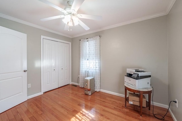 bedroom featuring crown molding, baseboards, and light wood-style floors