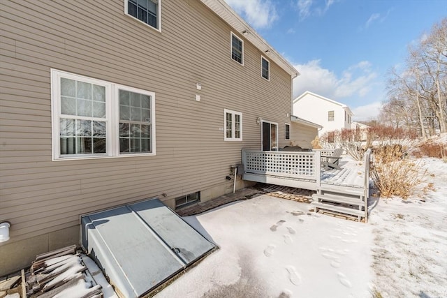 snow covered property featuring a deck