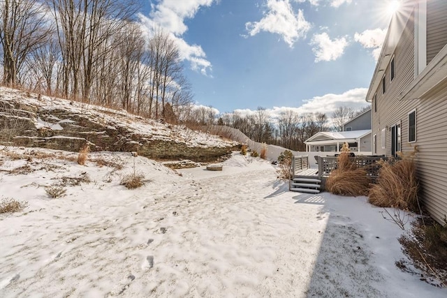 yard covered in snow featuring a wooden deck